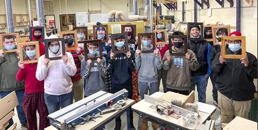 Tech Ed students posing with the frames they built in tech ed class